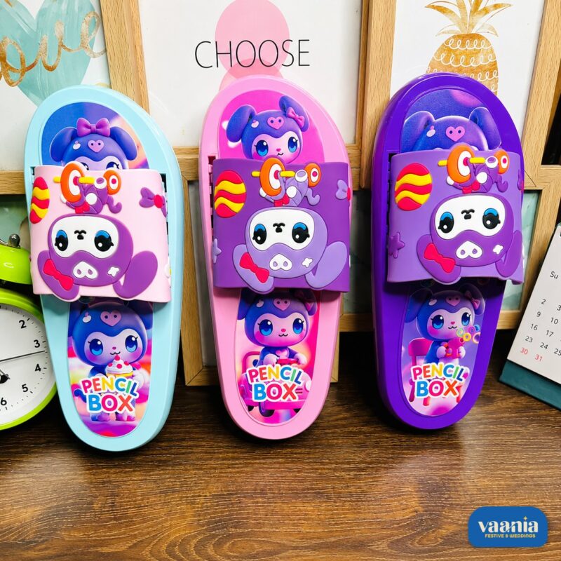 Three colorful Slipper Pencil Boxes in blue, pink, and purple featuring cute bear characters on a wooden desk. - view 2