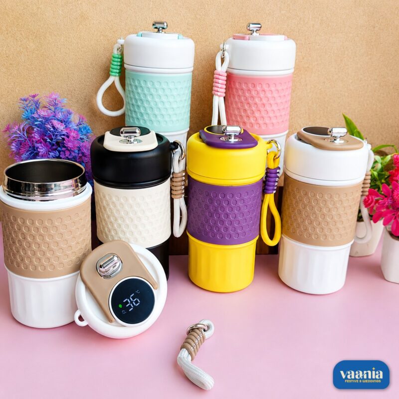 Collection of colorful insulated smart coffee mugs with digital temperature lids and silicone grips.