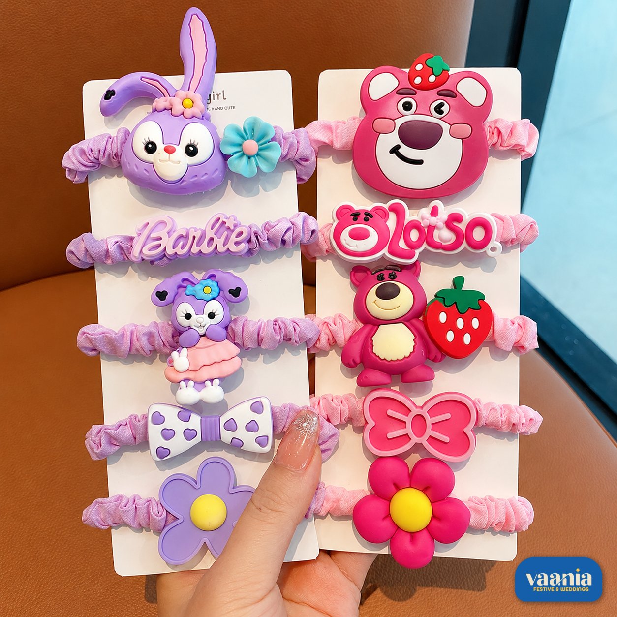 Cartoon Charm Hair Band Pack at Vaania Cartoon Charm Hair Band Pack featuring purple rabbit and pink strawberry bear charms on elastic bands.