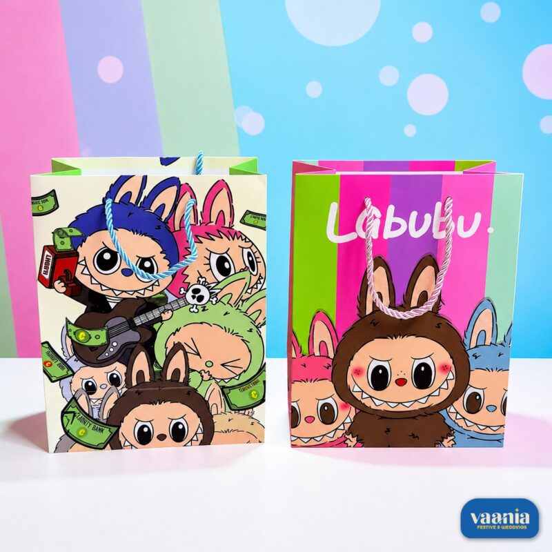 Two colorful Vaania 3D Carry Bags showcasing Labubu character graphics against a pastel striped background.