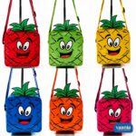 A young girl smiling and wearing a bright pink pineapple sling bag with a cartoon face and green leaves. - view 2