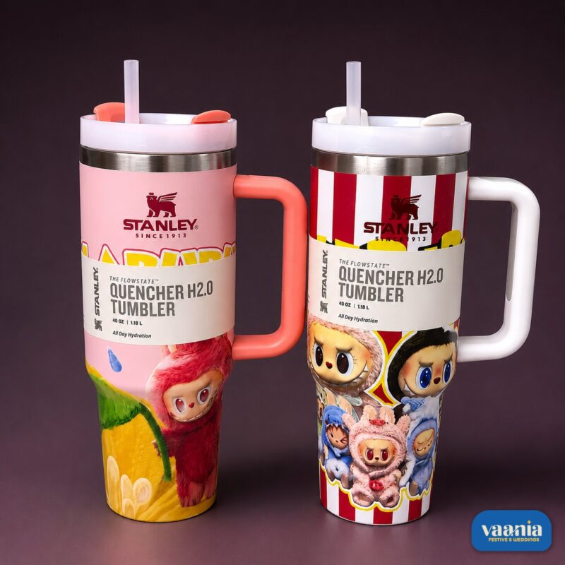 Two Labubu Stanley Tumbler Quenchers in pink and red-stripe patterns with cartoon graphics and ergonomic handles.