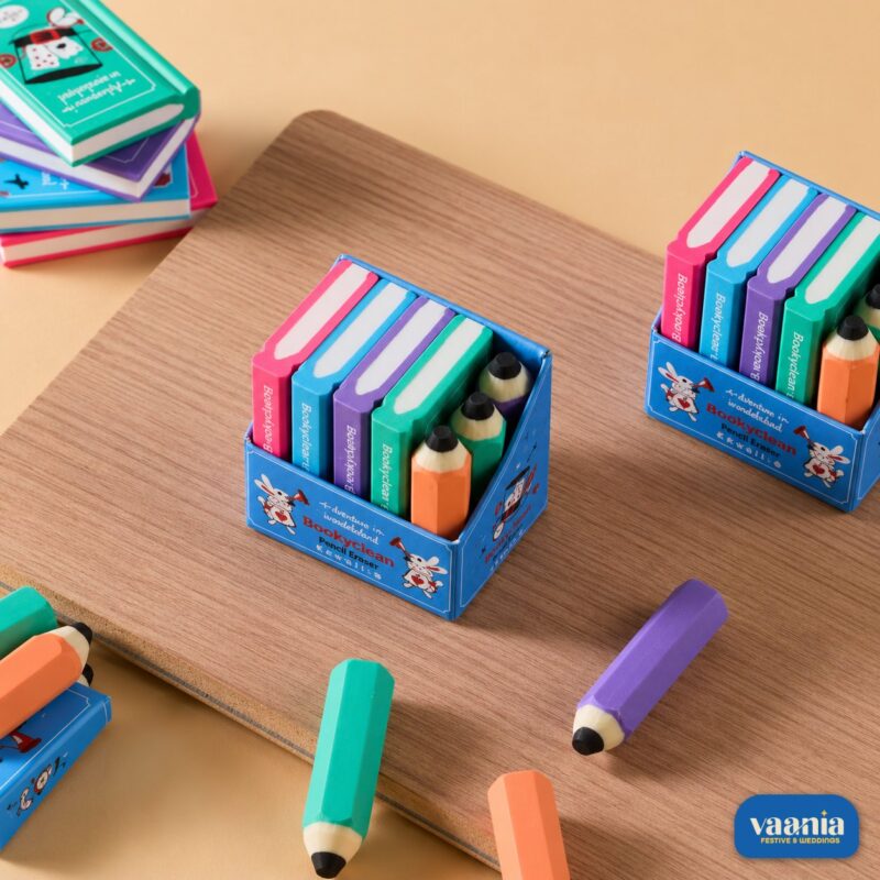 Colorful book and pencil shaped erasers displayed in a blue illustrated box titled Bookshelf Eraser. - view 2