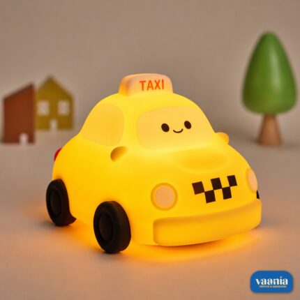 A glowing yellow Taxi Silicon Night Lamp with a smiling face on the windshield and black wheels.