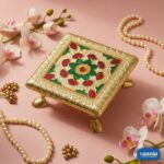Three golden Metal Leg Chowkis with colorful floral patterns and curved brass feet on a pink backdrop. - view 2