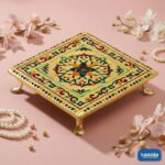 Top view of a square gold Metal Leg Chowki with colorful floral mandala patterns on a pink fabric background. - view 2