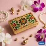 A stack of four golden nested Rectangular Chowkis with floral paintings surrounded by pink orchids and pearls. - view 2