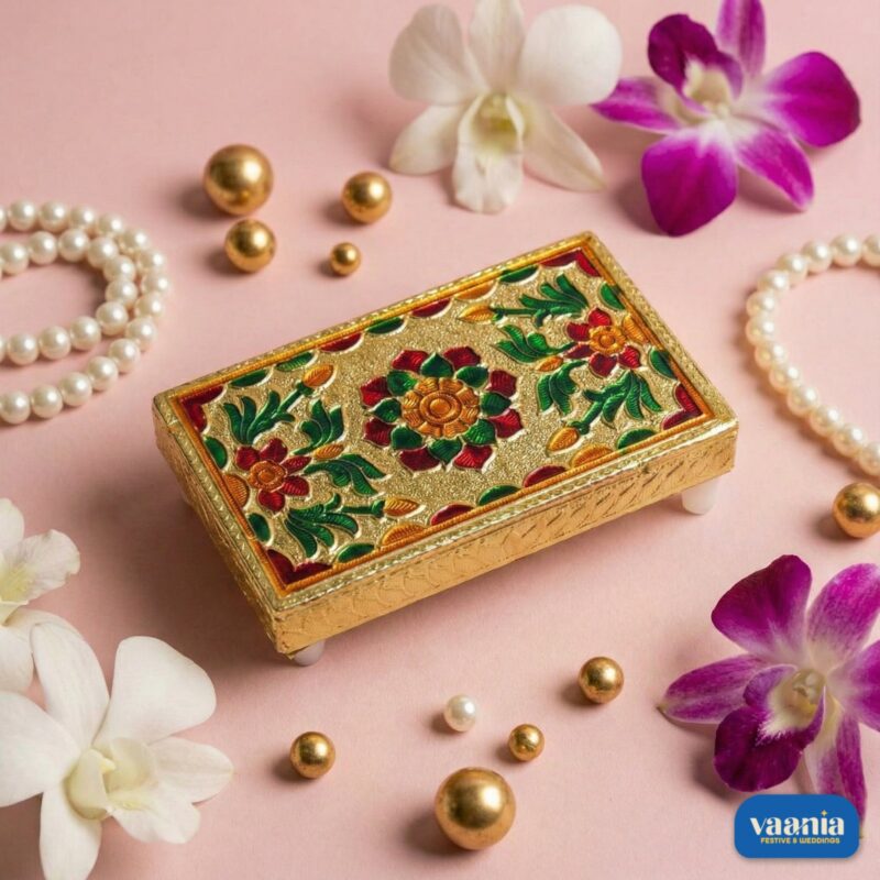 A stack of four golden nested Rectangular Chowkis with floral paintings surrounded by pink orchids and pearls. - view 2