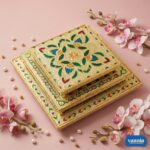 A stack of three Big Square Chowkis with gold finish and floral enamel patterns on a pink background.