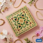 A stack of three Big Square Chowkis with gold finish and floral enamel patterns on a pink background. - view 3