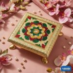 Three golden Metal Leg Chowkis with colorful floral patterns and curved brass feet on a pink backdrop. - view 3