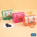 Three Multi Purpose Window Boxes in green, pink, and orange with floral patterns and braided handles