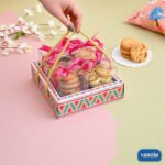 A decorative Hamper Tray with Boxes Compartment filled with cookies, featuring a colorful geometric base and gold handles.
