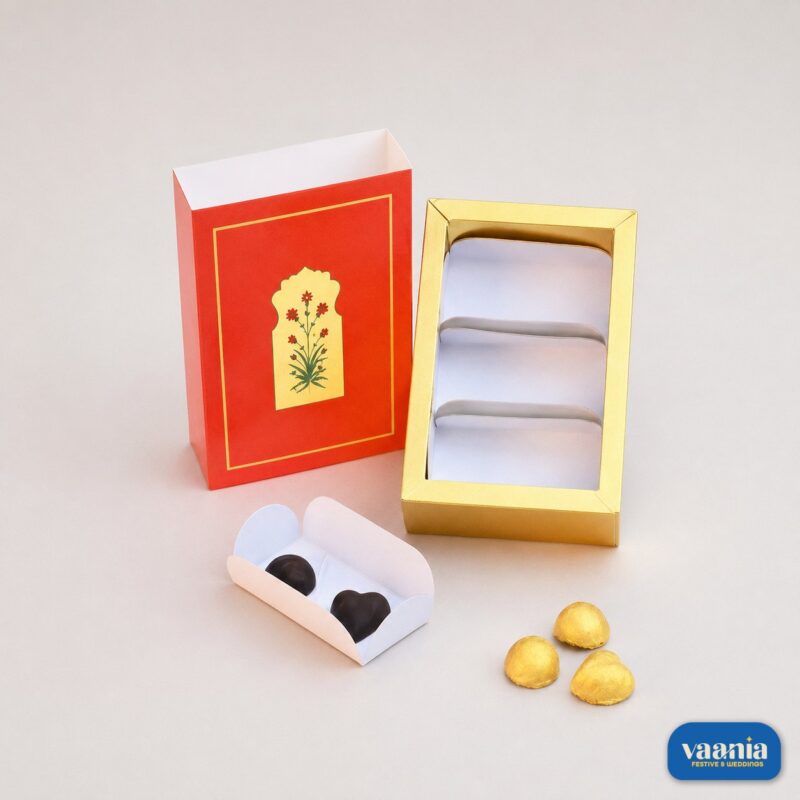 A red sliding sleeve with floral motif and a gold tray with three cavities for the Sliding Box - Cavity Box.