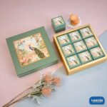 Green Top-Bottom Hamper featuring 9 inner boxes with peacock illustrations on a gold frame
