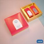 A pink and gold Top-Bottom Hamper with floral patterns including two inner window boxes on a pink and blue background.
