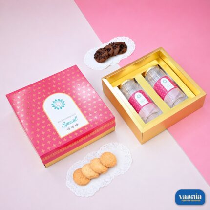 Top-Bottom Hamper featuring two pet jars in a gold tray next to its pink patterned lid and gourmet cookies