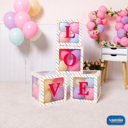 Four stacked Multi Purpose Window Boxes with LOVE letters and colorful balloons inside against a party backdrop.