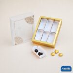 Sliding Box Cavity PVC Box with gold frame and mandala sleeve next to heart shaped chocolates