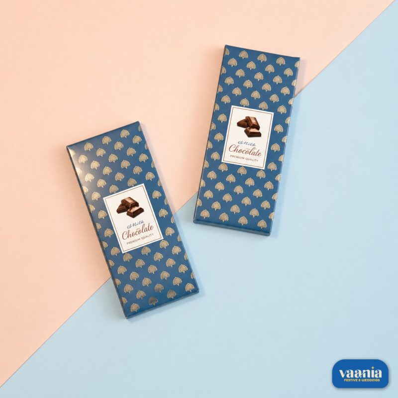 Two navy blue Premium Chocolate Bar Boxes with gold leaf patterns on a pink and blue background.