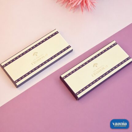 Two elegant cream and purple Premium Chocolate Bar Boxes with gold leaf lettering on a two-tone pink background.